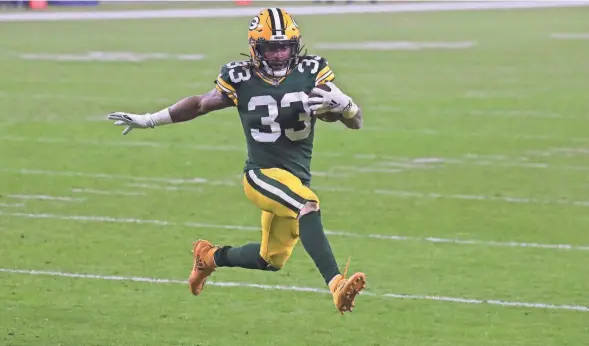  ?? MILWAUKEE JOURNAL SENTINEL ?? Packers running back Aaron Jones struts eight yards untouched into the end zone to score a touchdown during the second quarter of their game against the Carolina Panthers on Saturday. Please visit jsonline.com/sports for complete coverage.