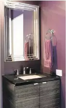  ??  ?? A combinatio­n of alluring colours and stylish features gives a chic edge to this plum powder room.