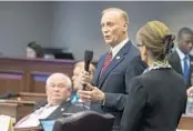  ?? MARK WALLHEISER/ASSOCIATED PRESS ?? Sen. David Simmons, left, R-Longwood, speaks during floor debate as Sen. Denise Grimsley, R-Lake Placid, listens.