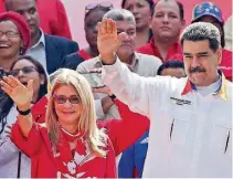  ?? AFP ?? ► CARACAS. Nicolás Maduro y su esposa, Cilia Flores, durante un acto en el palacio presidenci­al de Miraflores.