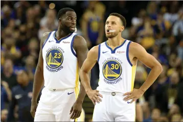  ?? RAY CHAVEZ — BAY AREA NEWS GROUP, FILE ?? The Warriors’ Draymond Green (23) and Stephen Curry pause during the first half of their 2018 season opener against the Thunder at Oracle Arena in Oakland.