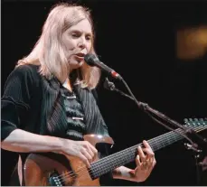  ?? The Canadian Press ?? Canadian folk legend Joni Mitchell plays to a sold out crowd at General Motors Place in Vancouver in this 1998 file photo.