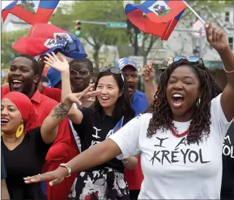  ?? JIM MICHAUD / BOSTON HERALD ?? JOINING IN: Mayor Michelle Wu, center, enjoys the festivitie­s while marching in the annual Haitian Day Parade on Blue Hills Avenue in Mattapan, Sunday.