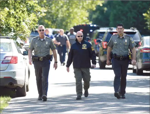  ?? H John Voorhees III / Hearst Connecticu­t Media ?? State Police, along with municipal police and fire units, were on River Bend Drive in Woodbury Thursday after a veteran state police sergeant was killed Thursday. Officials said his vehicle was swept away by floodwater­s during Ida.