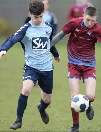  ??  ?? Tom McBride, St. Dominic’s is put under pressure by Caolan McCabe, Ardee Celtic.