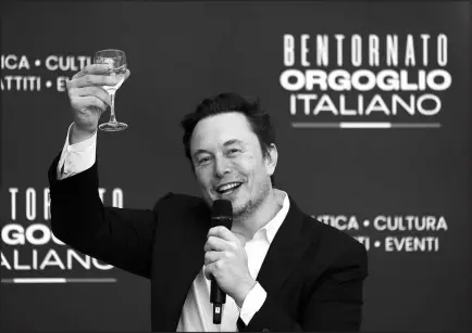  ?? ALESSANDRA TARANTINO / ASSOCIATED PRESS FILE (2023) ?? Elon Musk raises a glass Dec. 16 as he speaks at the annual political festival Atreju in Rome.