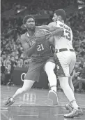  ?? AP ?? 76ers center Joel Embiid (21) drives to the basket against Celtics center Enes Freedom (13) during the second half on Monday in Boston.