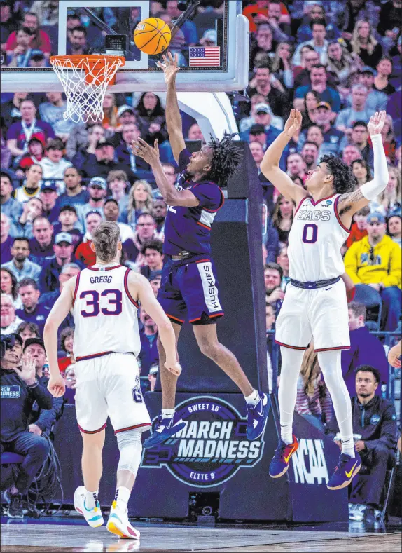  ?? L.E. Baskow Las Vegas Review-journal @Left_eye_images ?? Uconn guard Tristen Newton soars past Gonzaga guard Julian Strawther on Saturday during the Huskies’ 82-54 victory in the West Regional final at T-mobile Arena. The Huskies will play either Texas or Miami in Houston after advancing to their sixth Final Four.