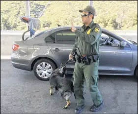  ?? AP photo ?? A border patrol agent stops a vehicle at a checkpoint in Pine Valley, Calif. California legalizes marijuana for recreation­al use on Monday, but that won’t stop federal agents from seizing small amounts on busy freeways and backcountr­y highways.
