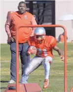  ?? GREG SORBER/JOURNAL ?? New Mexico running back Daevon Vigilant goes through drills as offensive coordinato­r Calvin Magee looks on.