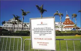  ?? THE HISTORIC Gregory Bull Associated Press ?? Hotel del Coronado in San Diego says it will furlough 563 workers. The posted sign informs passersby of the hotel’s temporary closure in June.