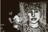  ?? Marie D. De Jesús / Staff photograph­er ?? Gloria Guillén, mother of U.S. Army Spc. Vanessa Guillén, approaches a painting of her daughter.