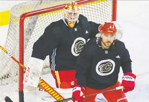  ?? GAVIN YOUNG ?? New Calgary Flames players goaltender Jacob Markstrom and defenceman Chris Tanev practise during the first day of training camp in Calgary on Monday.