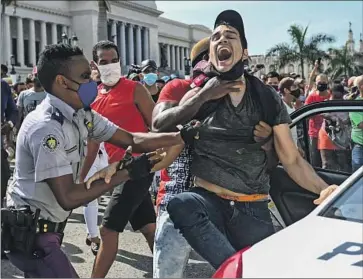  ?? Yamil Lage AFP/Getty Images ?? POLICE IN CUBA arrested hundreds during antigovern­ment demonstrat­ions on July 11, 2021. The country, along with Nicaragua and Venezuela, was not invited to the Summit of the Americas this week in Los Angeles.