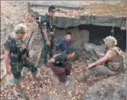  ?? AP ?? Members of the Karen National Liberation Army and People’s Defence Force examine two arrested soldiers after they captured an army outpost, in the southern part of Myawaddy township in Kayin state, Myanmar, on March 11