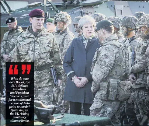  ??  ?? Theresa May with British troops in a Nato battle group in Estonia. A no deal Brexit, combined with President Trump’s isolationi­st stance, will leave Britain short of strategic allies.