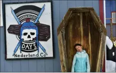  ?? HELEN H. RICHARDSON — THE DENVER POST ?? Gretchen Edwards, 6, poses for her mother Tina, inside a wooden coffin during Frozen Dead Guy Days on March 20, 2022, in Nederland. “I was inspired to try to look like I was dead,” Gretchen told her mother.