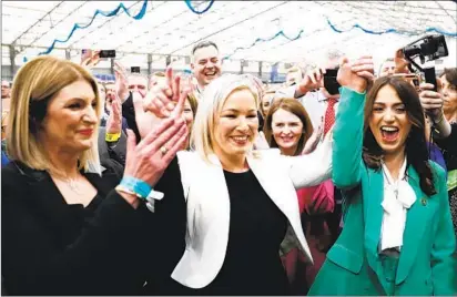  ?? PETER MORRISON AP ?? Sinn Fein’s Vice President Michelle O’neill (center) celebrates with colleagues in Northern Ireland. The Irish nationalis­t party secured the post of first minister for the first time since Northern Ireland was founded as a Protestant-majority state in 1921.