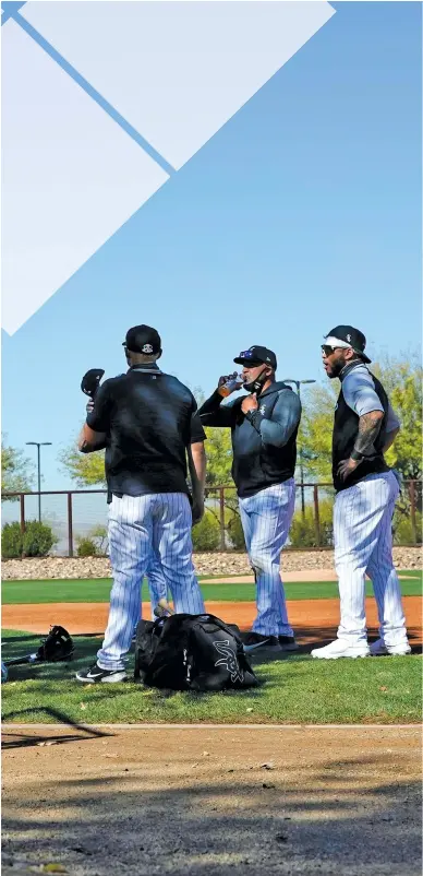  ?? ROSS D. FRANKLIN/AP ?? White Sox players gather on a practice field before going through drills during spring training in Glendale, Ariz.