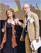  ?? COURTESY PHOTO ?? Nina Simons and Kenny Ausubel walk onstage to accept the 2017 Goi Peace Award. The pair were honored ‘for their pioneering work to promote nature-inspired innovation­s for restoring the Earth and our human community.’