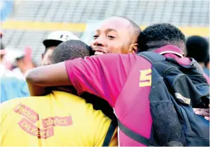  ??  ?? St Andrew Technical High School head coach Philip Williams (centre) embraces members of his technical staff after the penalty shoot-out in their ISSA/Digicel Manning Cup semi-final match against Wolmer’s Boys School at the National Stadium, in St Andrew, yesterday.