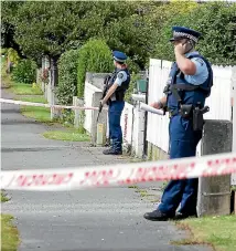  ??  ?? Armed police outside a property on Princess St, Invercargi­ll, after gunshots were fired in the early hours of yesterday morning. ROBYN EDIE/STUFF