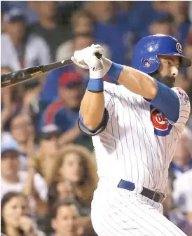  ?? | AP ?? The Cubs’ Alex Avila follows through on a bases- loaded single in the seventh inning Monday. The Cubs scored three runs on the play, thanks to two Pirates errors.