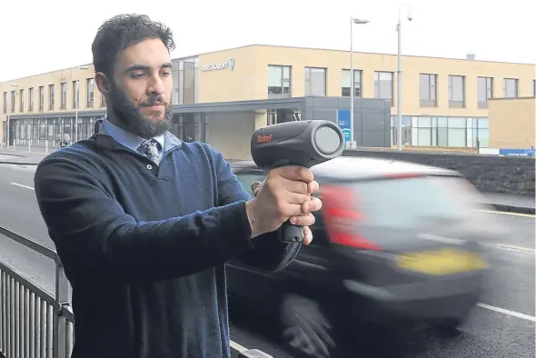  ??  ?? Tele reporter Adam Hill tests out the speed gun on Perth Road.