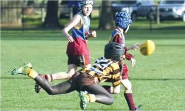  ??  ?? Warranor player Steward Oling makes a diving tackle on his Colts opponent during the under 10 match.