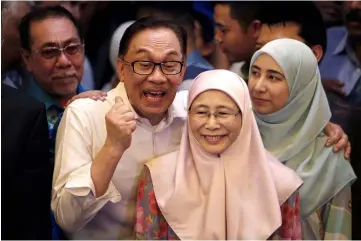  ?? — Reuters photo ?? Anwar in a jovial mood with his wife Wan Azizah and daughter (right) during a news conference in Kuala Lumpur.