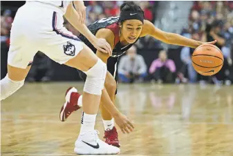  ?? David Dermer / Associated Press ?? Stanford’s Alexa Romano drives on UConn’s Katie Lou Samuelson in Columbus, Ohio.