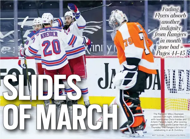  ?? MATT SLOCUM — THE ASSOCIATED PRESS ?? The Rangers’ Mika Zibanejad, second from right, celebrates with teammates Chris Kreider and Artemi Panarin, back, after scoring against Flyers goalie Carter Hart on Thursday. The Rangers did a lot of
celebratin­g in an 8-3victory.