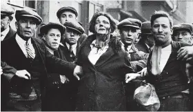 ?? HULTON ARCHIVE/GETTY IMAGES ?? A woman injured in the Old Market disturbanc­es in February. The riot was only the biggest event in a year of discontent and distress among those who were out of work