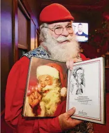  ?? Brian A. Pounds/Hearst Connecticu­t Media ?? Nick Gillotte, of Danbury, shows the version of “The the Night Before Christmas” in which he posed for Santa Claus illustrati­ons.
