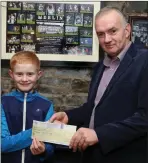  ??  ?? Above: Luke Lehane of Meelin Wren Group presenting a Cheque for €1,182 to Neily Curtin for Cancer Connect.