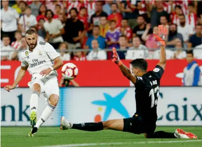  ?? AFP ?? Real Madrid’s Karim Benzema (left) shoots past Girona goalkeeper Yassine Bounou during the Spanish La Liga match. —