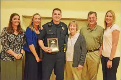  ?? LEAH MCDONALD — ONEIDA DAILY DISPATCH ?? From left, Courtney Warner, Sarah Hornyak, Officer Ryan Warner, Connie Warner, Wayne Warner and Kara Onyan pose after Ryan was awarded the Police Officer of the Year Award on Friday, May 6, 2016, at the Kallet Civic Center in Oneida.