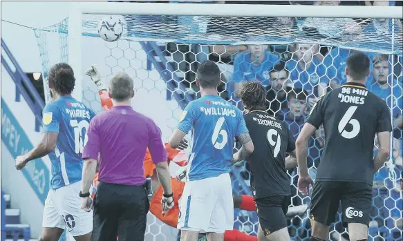  ?? Picture: Joe Pepler ?? DOUBLE TROUBLE The ball flies into the top corner as Cambridge United take a two-goal lead over Pompey at Fratton Park