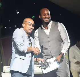  ?? OKOYE HENRY ?? Delano ‘DJ Delano’ Thomas (left), consultant and head of Silent Noise by Delano Ltd., presents a certificat­e to Duewayne ‘Skippy’ Blake, entertainm­ent director at Grand Palladium, for completing the DJ training programme.