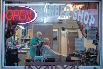  ?? JOSEPH RUSHMORE/THE NEW YORK TIMES ?? Barbershop­s and hair salons are reopening in a few states. That can’t come quickly enough for some Floridians.