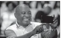  ?? AP/THEMBA HADEBE ?? Cyril Ramaphosa takes a selfie Monday after the announceme­nt that he was elected leader of South Africa’s ruling African National Congress.