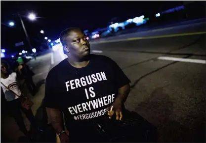  ?? SCOTT OLSON — GETTY IMAGES ?? Demonstrat­ors, marking the one-year anniversar­y of the shooting of Michael Brown, protest along West Florrisant Street on Aug. 11, 2015, in Ferguson, Missouri.