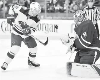  ??  ?? Wild winger Jason Zucker tries to swat a rebound past Maple Leafs goalie Frederik Andersen during third-period action in Toronto on Wednesday.