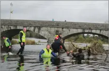  ??  ?? Volunteers from the Blackwater SAC hard at work cleaning up debris from the fish pass and weir in Fermoy.