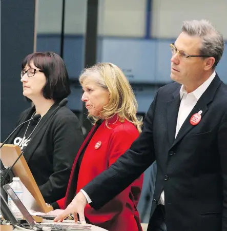  ?? JIM WELLS ?? Calgary 2026 CEO Mary Moran, centre and chair Scott Hutcheson, right, wait for the city council votes on Wednesday.