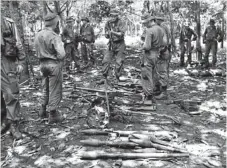  ?? Photo: AAP/ The Australian War Memorial ?? Australian soldiers gathering Vietnamese equipment after the Battle of Long Tan.