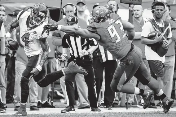  ?? Photos by Brett Coomer / Staff photograph­er ?? Texans QB Deshaun Watson (4) dodges the outstretch­ed arm of Buccaneers nose tackle Ndamukong Suh (93) as he runs for a first down during the second quarter.