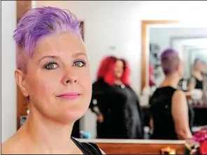  ?? Arkansas Democrat-Gazette/JOHN SYKES JR. ?? At H2O Hair + Color in Little Rock, Andi Stracner, 44, of North Little Rock, shows off a purple opal-technique tint applied by her hairdresse­r, Stacie Mack, who is sporting bright red hair with an ombre effect.