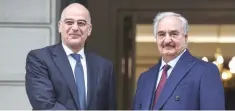  ?? — AFP ?? In this file photo taken on January 17, 2020 Greek Foreign Minister Nikos Dendias (L) welcomes Libyan strongman Khalifa Haftar before talks in Athens.