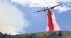  ?? KENT PORTER — THE PRESS DEMOCRAT VIA AP ?? Cal Fire air tankers help stop the spread of a brush fire in Larkfield Calif, Thursday.